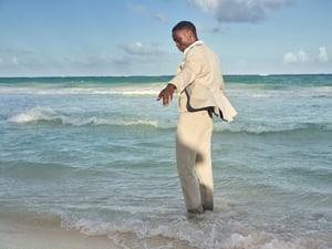 Man with suit by the sea