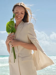 Bride in an off-white suit at the beach