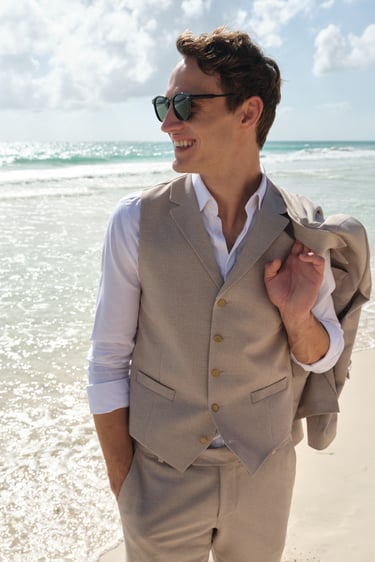Man with jacket on the beach