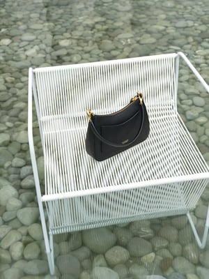 black bag on a white chair 