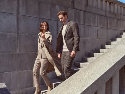 Frau mit schickem Mantel und Mann mit Anzug